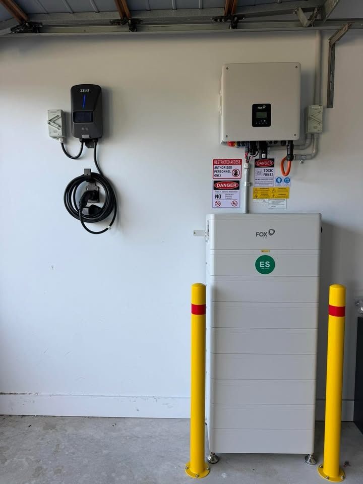 Battery, hybrid inverter and EV charger installed on one garage wall