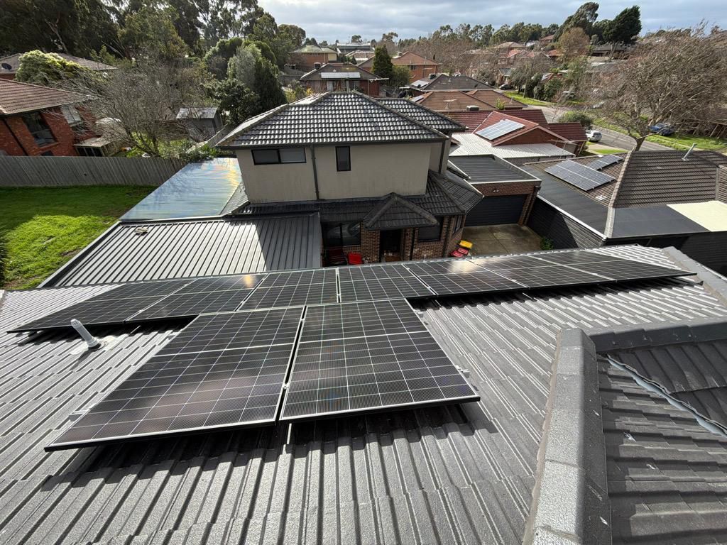 Solar panels distributed across multiple roof sections of a double-storey home